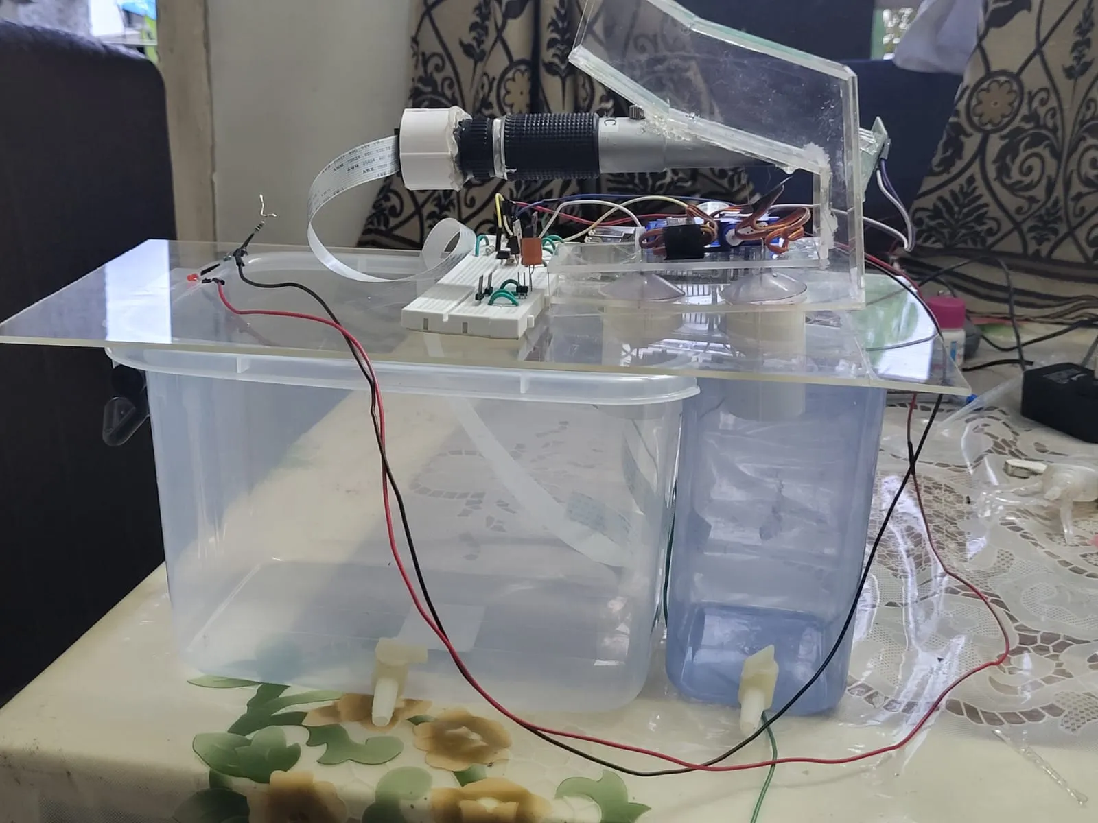 DEF prototype: refractometer, Pi Camera and wiring on an acrylic deck over two storage tanks